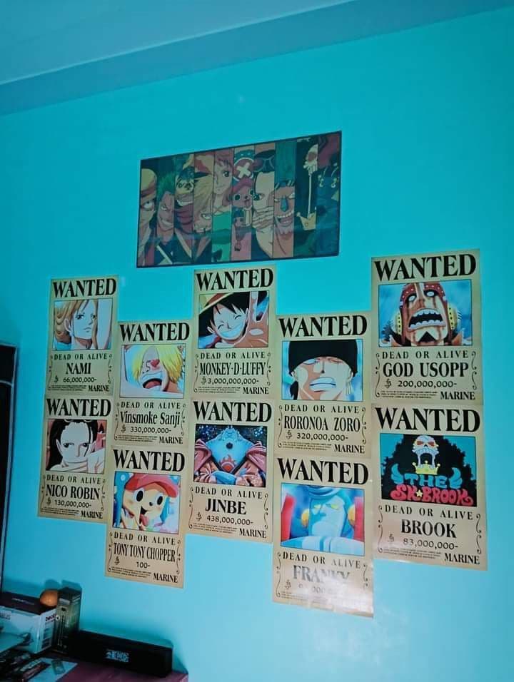 One Piece wanted posters arranged on a bedroom wall